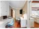 Bright home office featuring custom built-ins, a long desk, and hardwood floors at 118 Duncansby Ct, Cary, NC 27511