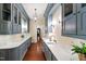 Butler's pantry with custom blue cabinets, marble counters, and ample storage at 118 Duncansby Ct, Cary, NC 27511