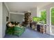 Outdoor porch with a stone fireplace, built-in grill, and comfortable seating area at 118 Duncansby Ct, Cary, NC 27511