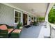 Inviting porch with cozy wicker seating, a ceiling fan, and views of the lush surroundings at 118 Duncansby Ct, Cary, NC 27511