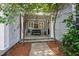 Covered front porch with a bench and lantern lighting, framed by trees and landscaping at 118 Duncansby Ct, Cary, NC 27511