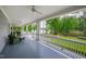 Spacious covered porch with comfortable seating, ceiling fans, and picturesque lake views at 118 Duncansby Ct, Cary, NC 27511