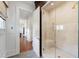 Luxurious tiled shower with glass door and bench, connected to the rest of the house via a hallway at 118 Duncansby Ct, Cary, NC 27511