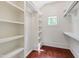 Spacious walk-in closet with built-in shelves and a charming window for natural light at 118 Duncansby Ct, Cary, NC 27511