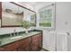 Bathroom with a double vanity, green granite countertop, and a large mirror at 121 Ladybug Ln, Chapel Hill, NC 27516
