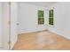 Sunlit bedroom with hardwood floors and windows offering serene outdoor views at 121 Ladybug Ln, Chapel Hill, NC 27516