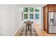 Bright dining area with large windows, modern lighting fixtures, and hardwood floors at 121 Ladybug Ln, Chapel Hill, NC 27516