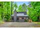 Modern style home with a gray exterior nestled among mature trees at 121 Ladybug Ln, Chapel Hill, NC 27516