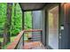 Cozy porch featuring a wood railing and a glass door overlooking the lush greenery at 121 Ladybug Ln, Chapel Hill, NC 27516