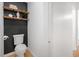 Modern powder room featuring black accent wall with floating shelves at 121 Ladybug Ln, Chapel Hill, NC 27516