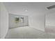 Large, carpeted bedroom with a light fixture and windows providing natural light at 1215 Pond Overlook Drive, Nashville, NC 27856