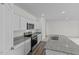 Modern kitchen featuring granite countertops, stainless steel appliances, and white cabinets at 1215 Pond Overlook Drive, Nashville, NC 27856