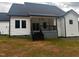Gorgeous back porch featuring a black railing and steps leading into the yard at 123-125 Ottawa Dr., Louisburg, NC 27549