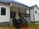 View of newly built back porch with stairs and wooden railing of a single Gathering home at 123-125 Ottawa Dr., Louisburg, NC 27549