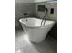 Modern free-standing bathtub with marble-look tile floor at 123-125 Ottawa Dr., Louisburg, NC 27549