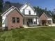 Charming two-story home with brick accents, a black roof, and a freshly cut green lawn at 123-125 Ottawa Dr., Louisburg, NC 27549