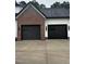 Two-car garage with brick and siding exterior at 123-125 Ottawa Dr., Louisburg, NC 27549