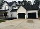Charming home with a two-car garage and black accents on white brick at 123-125 Ottawa Dr., Louisburg, NC 27549