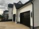 Attached two-car garage with black doors and a white exterior at 123-125 Ottawa Dr., Louisburg, NC 27549