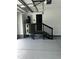 Spacious garage interior with finished floors, water heater, and access stairs at 123-125 Ottawa Dr., Louisburg, NC 27549