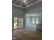 Spacious living room with tray ceiling, sliding glass door, and ample natural light at 123-125 Ottawa Dr., Louisburg, NC 27549