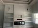 Bright living room featuring a modern electric fireplace, built-in shelving, and recessed lights at 123-125 Ottawa Dr., Louisburg, NC 27549