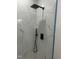 Modern shower with black fixtures and marble-look tile for a sleek design at 123-125 Ottawa Dr., Louisburg, NC 27549
