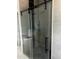 Modern glass shower enclosure with black hardware and gray tile surround at 123-125 Ottawa Dr., Louisburg, NC 27549