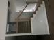New home staircase with natural wood railings and white walls at 123-125 Ottawa Dr., Louisburg, NC 27549