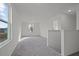 Open hallway with new neutral carpet and plenty of natural light at 1235 Pond Overlook Drive, Nashville, NC 27856