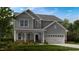 Charming two-story home featuring gray siding, a covered front porch, and an attached two-car garage at 132 Seagraves Creek Ln, Holly Springs, NC 27540