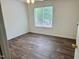 Bedroom with wood floors and a window at 1321 Crab Orchard Drive # 203, Raleigh, NC 27606