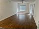 Bright living room featuring wood floors, a ceiling fan, and natural light at 1321 Crab Orchard Drive # 203, Raleigh, NC 27606