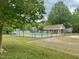 Community pool with fenced-in area, a nearby clubhouse, and surrounded by lush greenery at 1321 Crab Orchard Drive # 203, Raleigh, NC 27606
