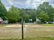 View of community recreation area with sand volleyball court and fenced-in basketball court at 1321 Crab Orchard Drive # 203, Raleigh, NC 27606