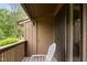 Balcony featuring a white Adirondack chair overlooking lush greenery at 1504 Oak Tree Dr, Chapel Hill, NC 27517