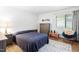 Comfortable bedroom featuring wood floors, a large window and tasteful decor at 1504 Oak Tree Dr, Chapel Hill, NC 27517