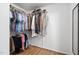Organized walk-in closet with ample hanging space and wood laminate flooring at 1504 Oak Tree Dr, Chapel Hill, NC 27517