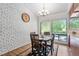 Bright dining area with white brick wall and views of the backyard at 1504 Oak Tree Dr, Chapel Hill, NC 27517