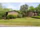 View of the condo's exterior, showcasing well-maintained landscaping, mature trees, and peaceful neighborhood surroundings at 1504 Oak Tree Dr, Chapel Hill, NC 27517