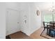 Bright foyer with white brick accent wall, and view into the dining area at 1504 Oak Tree Dr, Chapel Hill, NC 27517