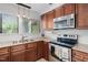 Close up of stainless steel oven and microwave and granite counters at 1504 Oak Tree Dr, Chapel Hill, NC 27517