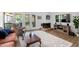 Open concept living room featuring wood floors, fireplace, and an abundance of natural light at 1504 Oak Tree Dr, Chapel Hill, NC 27517