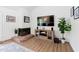 Cozy living room with brick fireplace, mounted television, and decorative accents at 1504 Oak Tree Dr, Chapel Hill, NC 27517