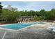 Sparkling community pool with ample lounging space, promising relaxation and recreation for residents at 1504 Oak Tree Dr, Chapel Hill, NC 27517