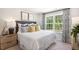 Inviting bedroom with a comfortable bed, stylish linens, and plenty of natural light at 176 Holmes Corner Dr, Smithfield, NC 27577