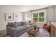 Comfortable living room with a gray sofa, an orange chair, and natural light at 176 Holmes Corner Dr, Smithfield, NC 27577