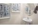 Elegant powder room featuring a pedestal sink and modern artwork at 176 Holmes Corner Dr, Smithfield, NC 27577