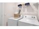 Neat laundry area featuring a white washer and dryer, plus shelving for storage at 188 Holmes Corner Dr, Smithfield, NC 27577