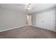 Bedroom offers a ceiling fan, carpet, large closet, and access to an ensuite bathroom at 1903 Malone Rd # E, Burlington, NC 27215